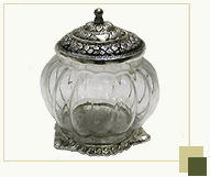Glass decorative jar with silver antique top