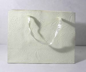 embossed paper with floral design all over bag