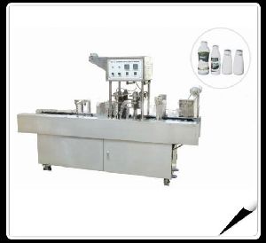 Automatic milk bottles filling and sealing machine